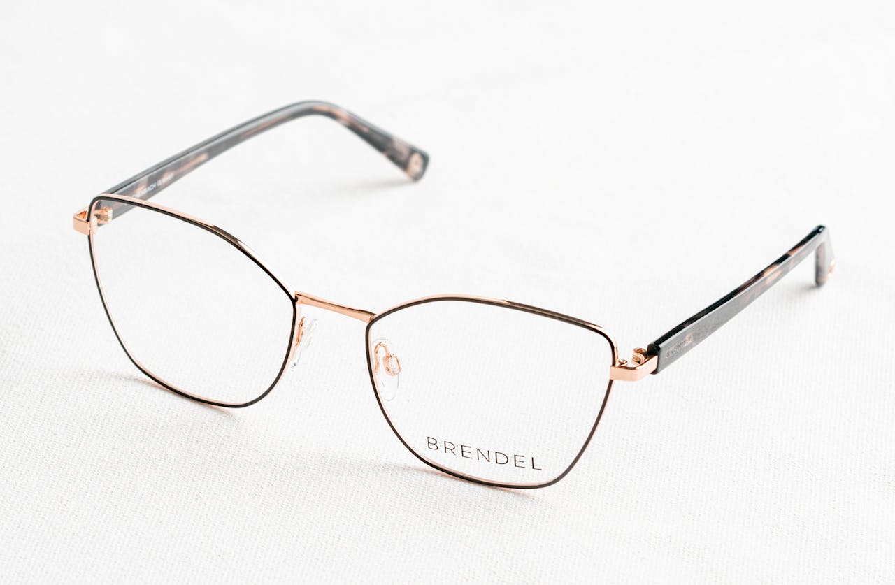 services-02 Close-up of stylish gold eyeglasses with 'BRENDEL' branding on a clean white surface.